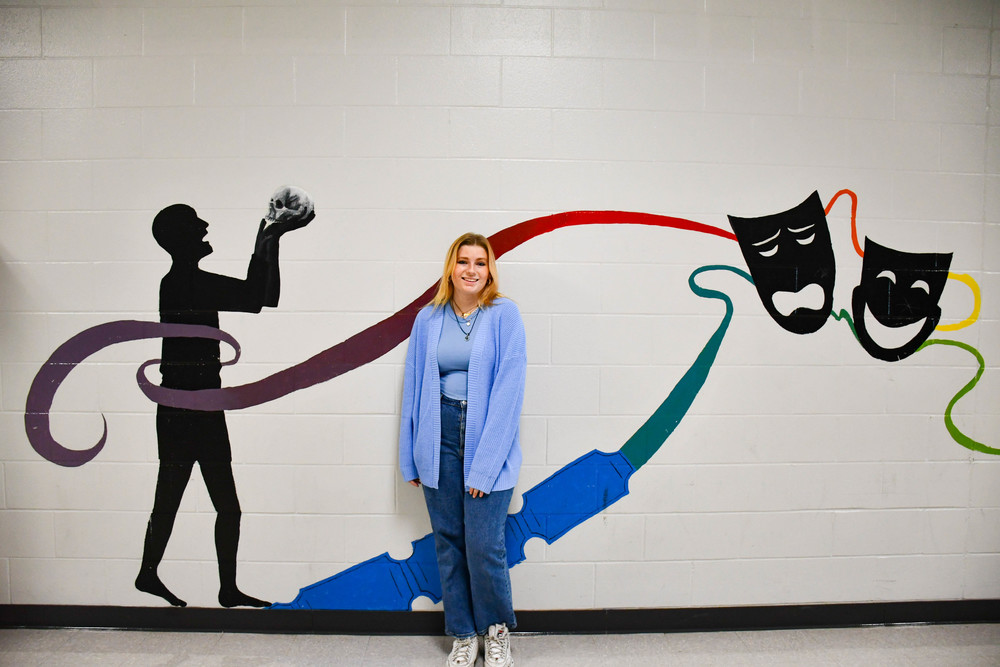 Bryan High senior Grace DuBose in front of a theater arts mural