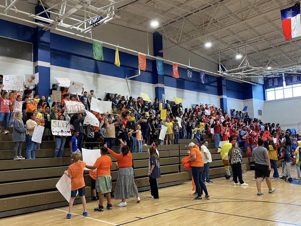 Rayburn sixth graders in rainbow colors at pep rally