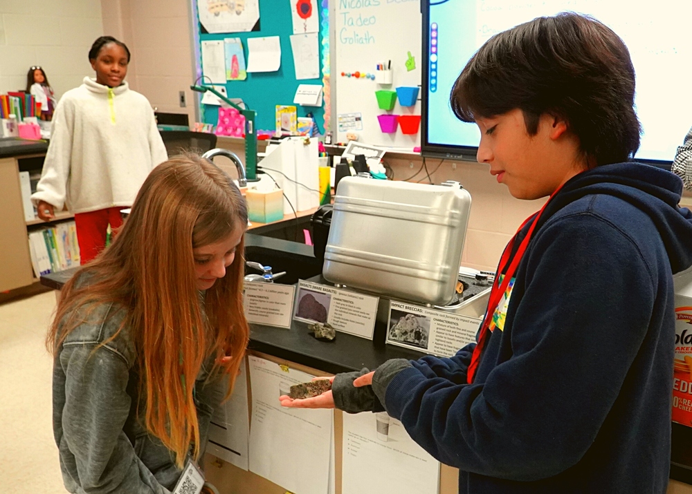 Student shows other students moon rocks