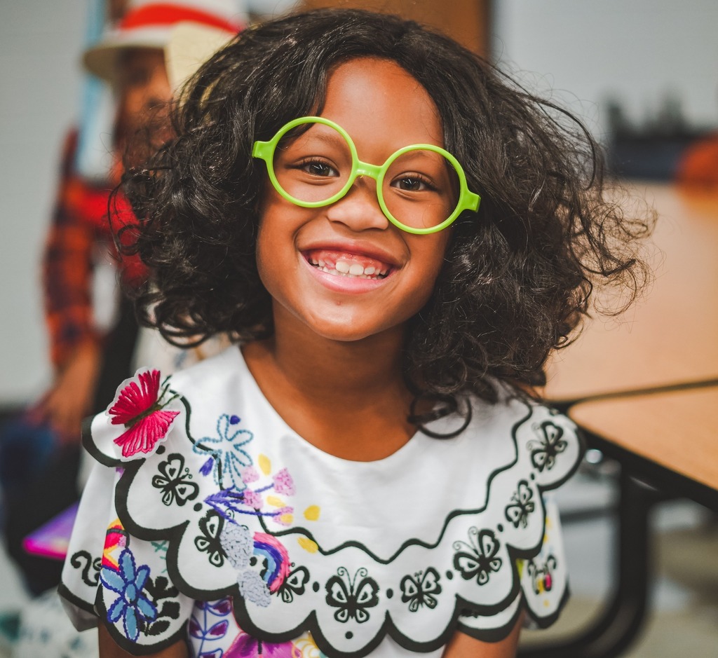 Girl smiling with green glasses