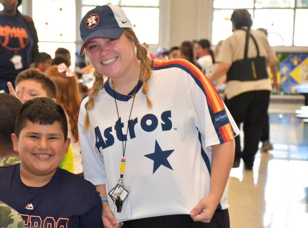 Mitchell Elementary student and staff member showing off their Houston Astros gear in celebration of the Astros' World Series win.
